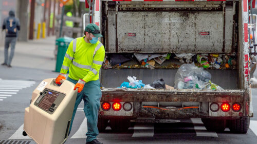 oxygen concentrator being thrown in garbage truck